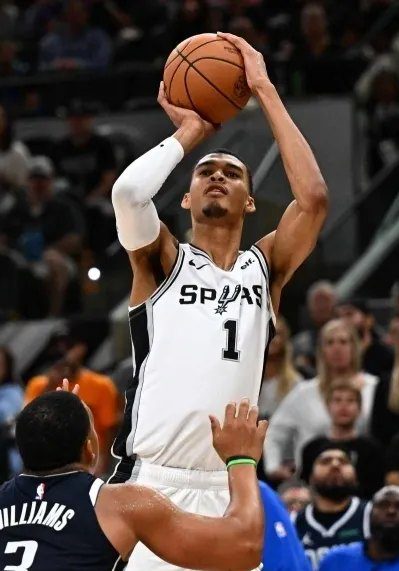 A man holding onto the basketball in his hand