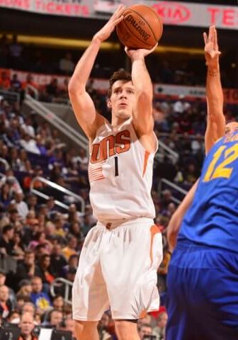 A basketball player is about to hit the ball.