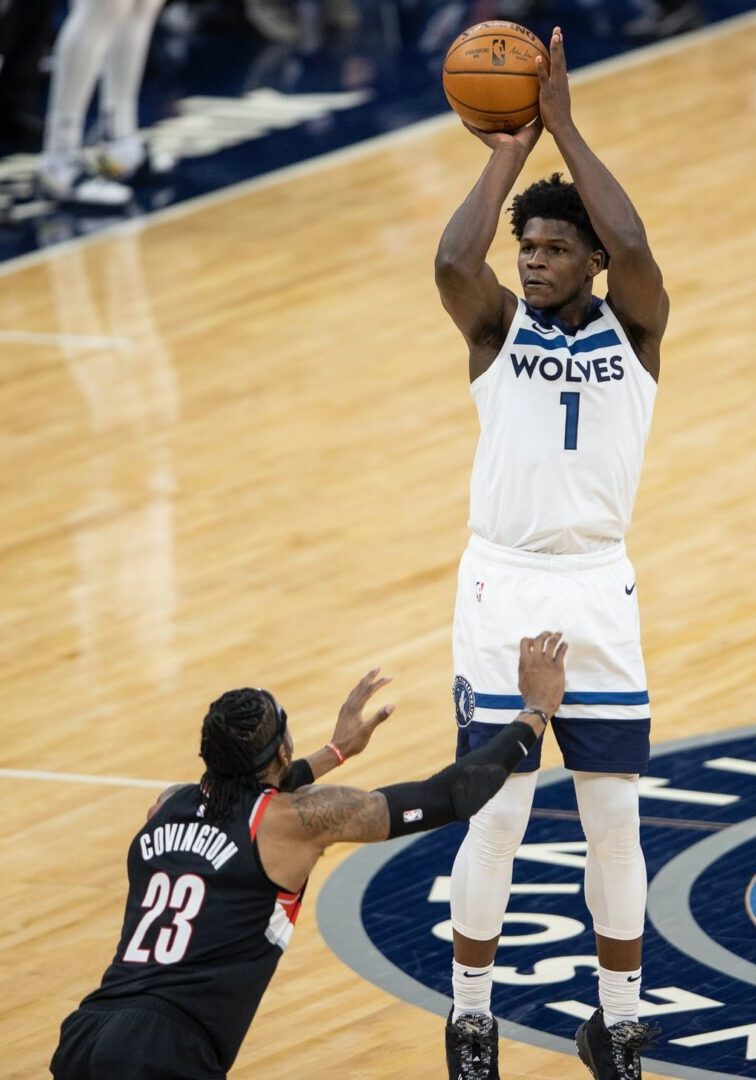 A basketball player is about to shoot the ball.