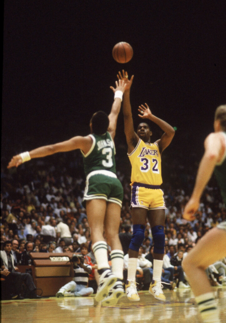 LOS ANGELES - 1987:  Magic Johnson #32 of the Los Angeles Lakers shoots over Dennis Johnson #3 of the Boston Celtics during an NBA Finals game at the Great Western Forum in Los Angeles, California in 1987. (Photo by: Mike Powell/Getty Images)
