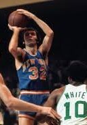 A man in blue jersey holding a basketball.
