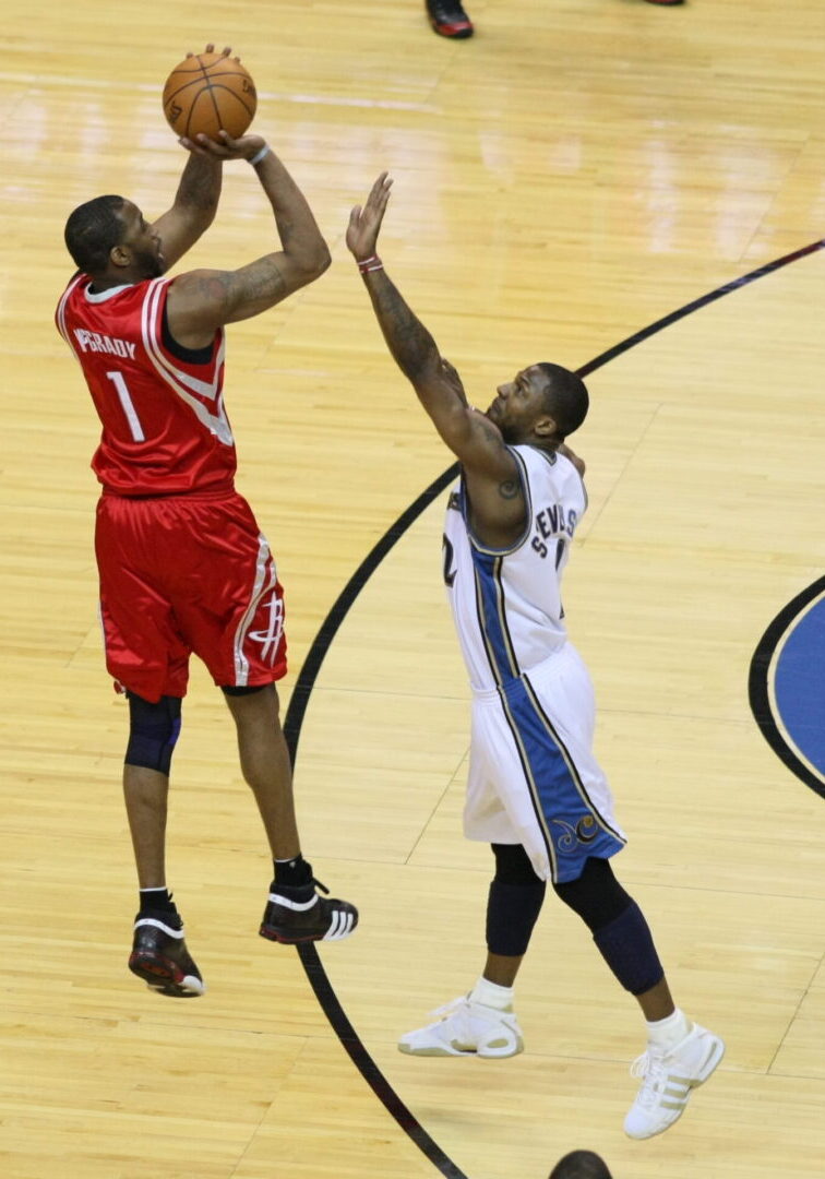 Two men playing basketball on a court