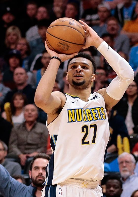 A man holding a basketball in the air.