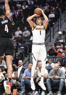 A man is taking a jump shot at an event