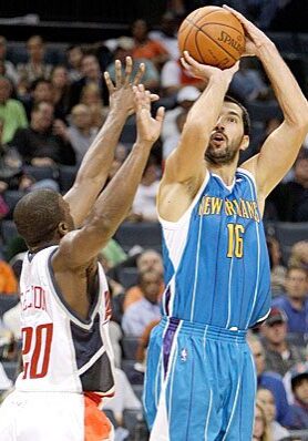 A man in blue jersey holding a basketball.