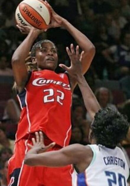 A basketball player is jumping to the air.