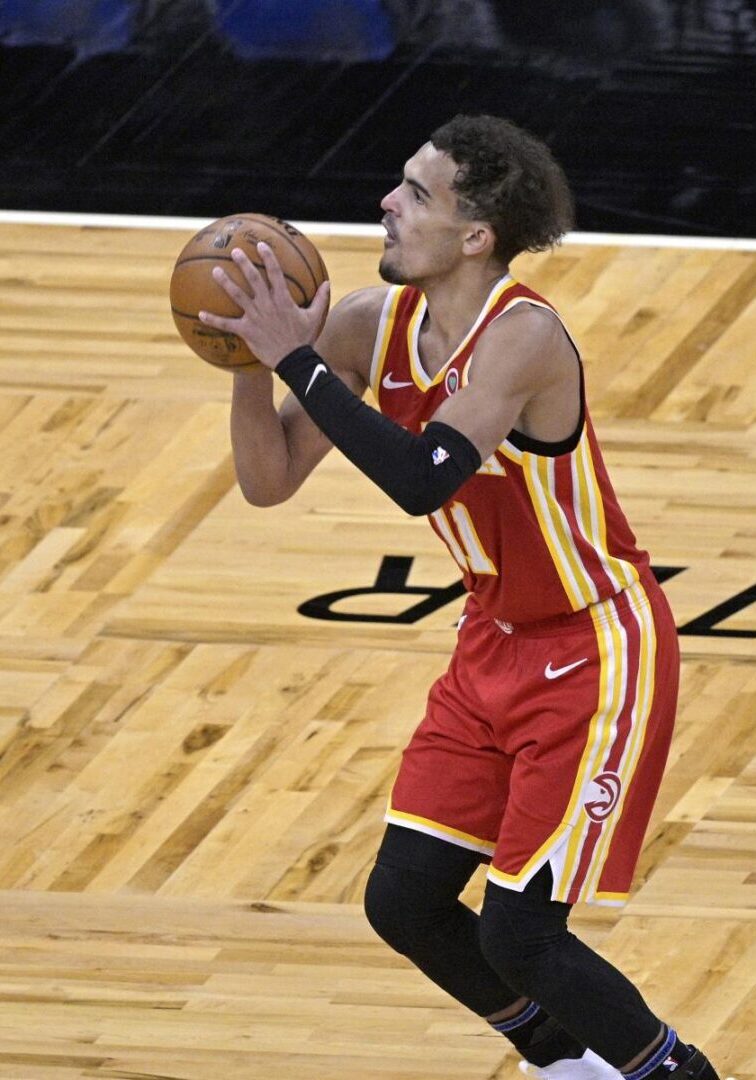 A basketball player is holding the ball and ready to shoot.